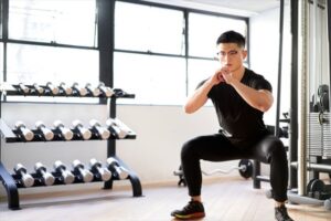 手を胸の前で組む中腰の男性