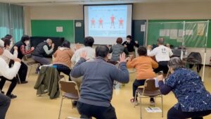 中腰のまま顔の横で手を開く人たち